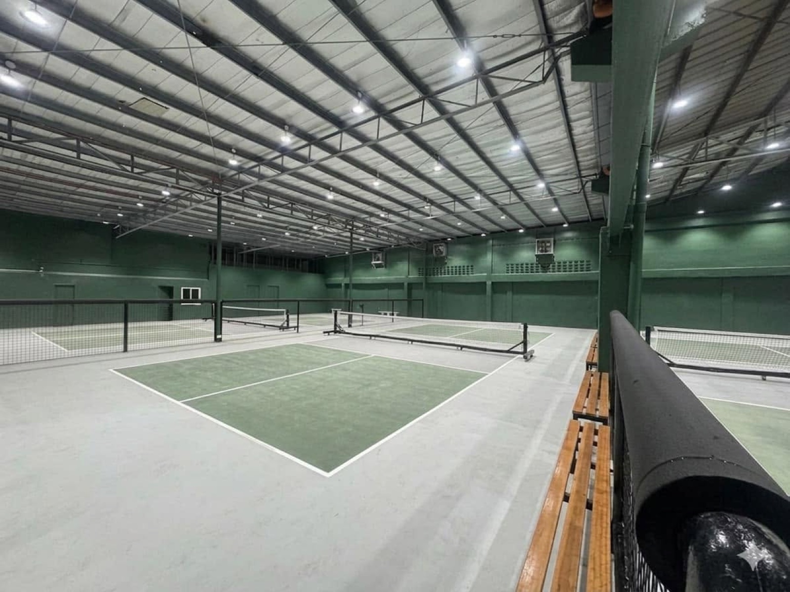 A wide overview of the indoor courts and spectator benches