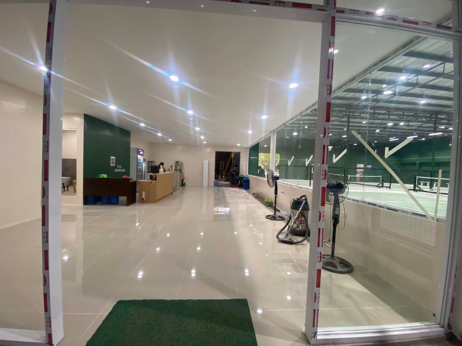 The bright Hoops & Racket lobby overlooking the courts